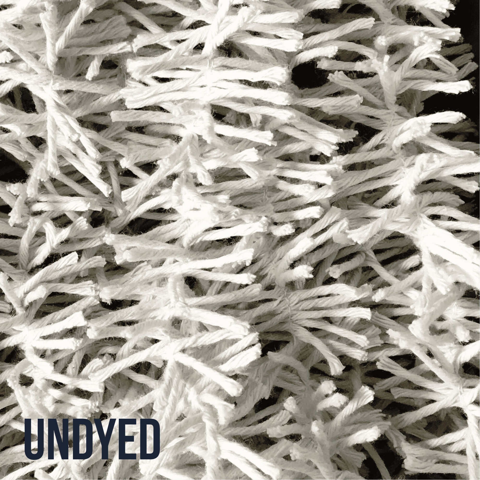 Close up of plain cotton Strinsel string tinsel with the title UNDYED in the lower left hand corner