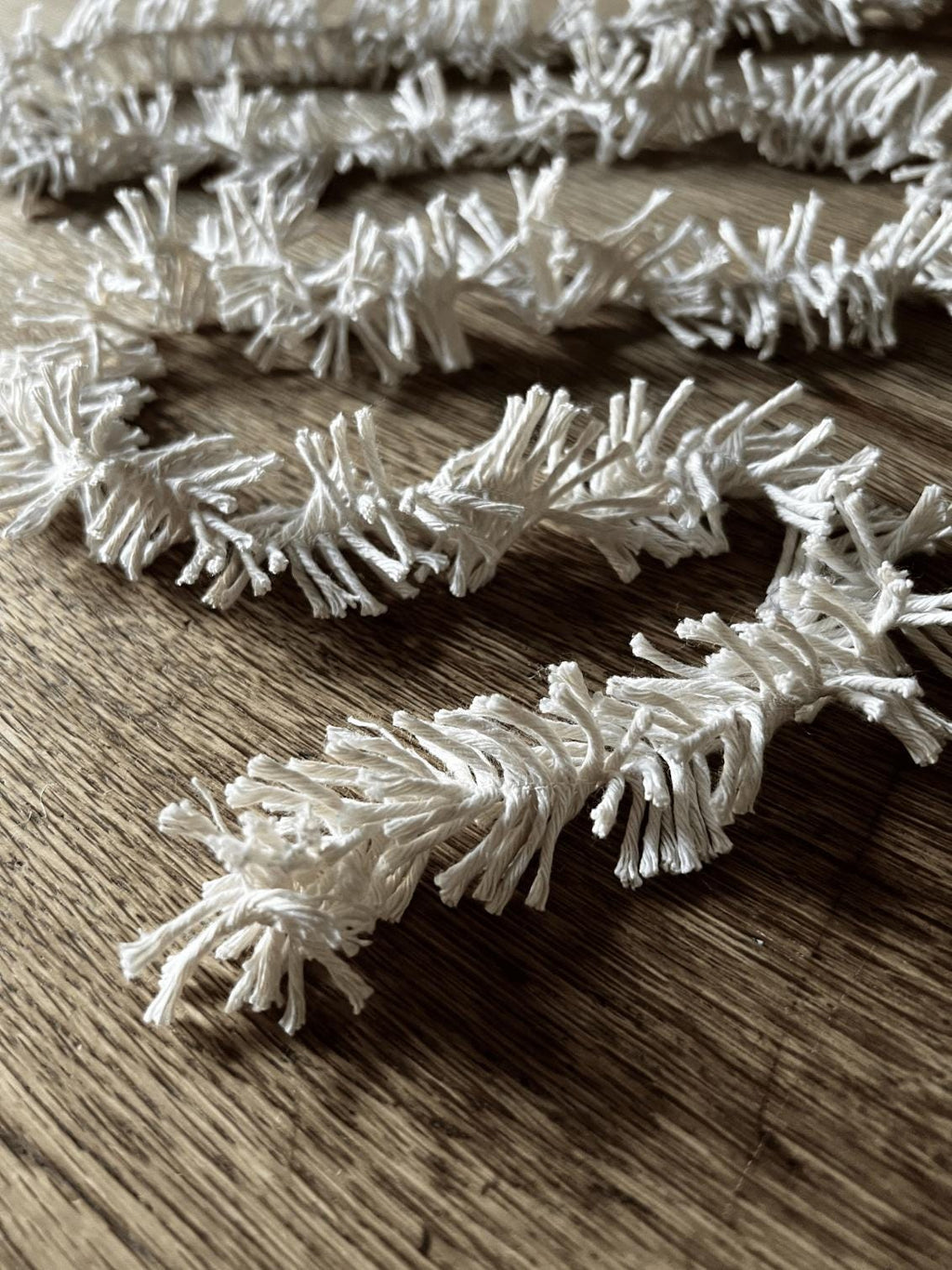 Decorative Strinsel string tinsel garland  on a wooden background