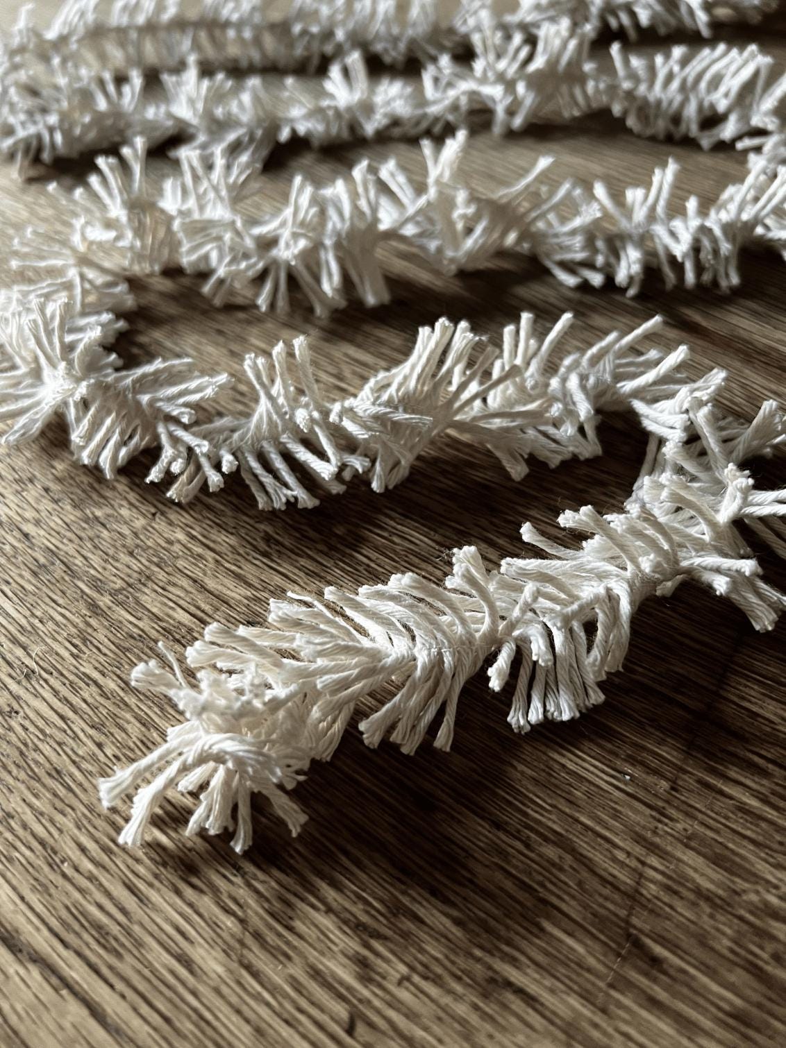 Decorative Strinsel string tinsel garland  on a wooden background
