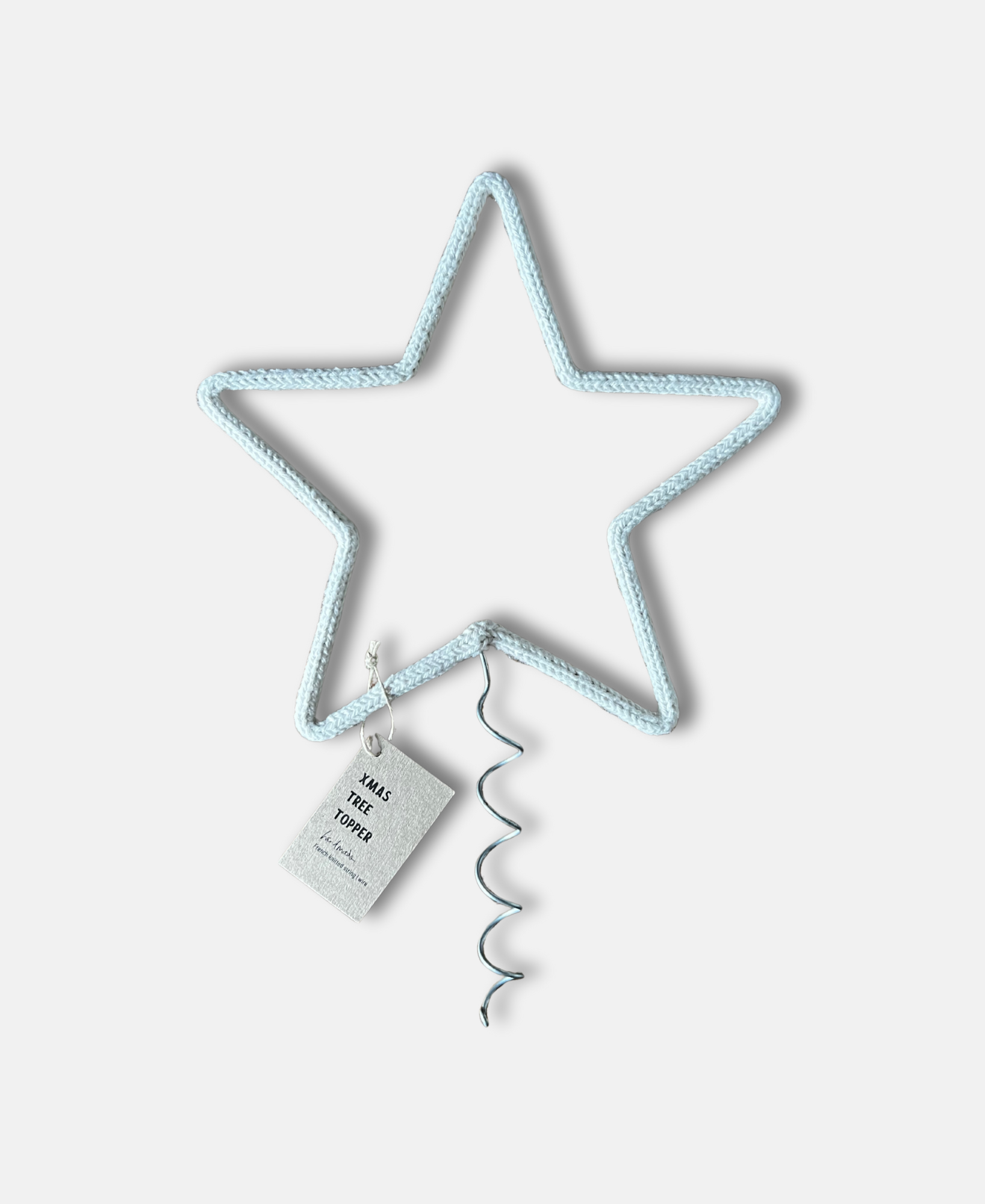 Star-shaped tree topper with a tag on a white background