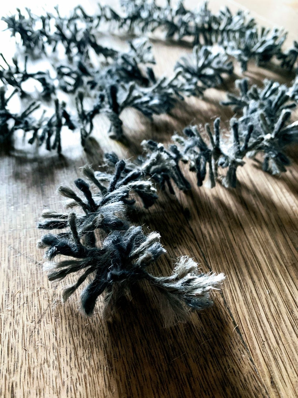 Silvery Pewter Strinsel jute string tinsel on a wooden background