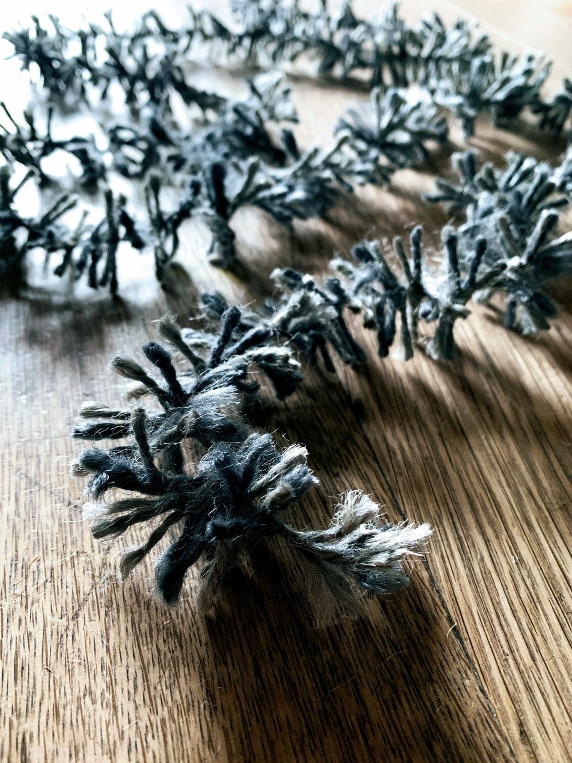 Silvery Pewter Strinsel jute string tinsel on a wooden background