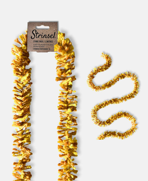 Bright gold Strinsel jute string tinsel with and without packaging on a pale grey background