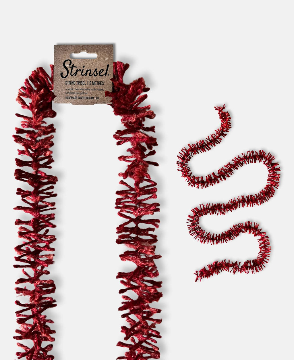 Deep Red Strinsel jute string tinsel with and without a label on a pale grey background