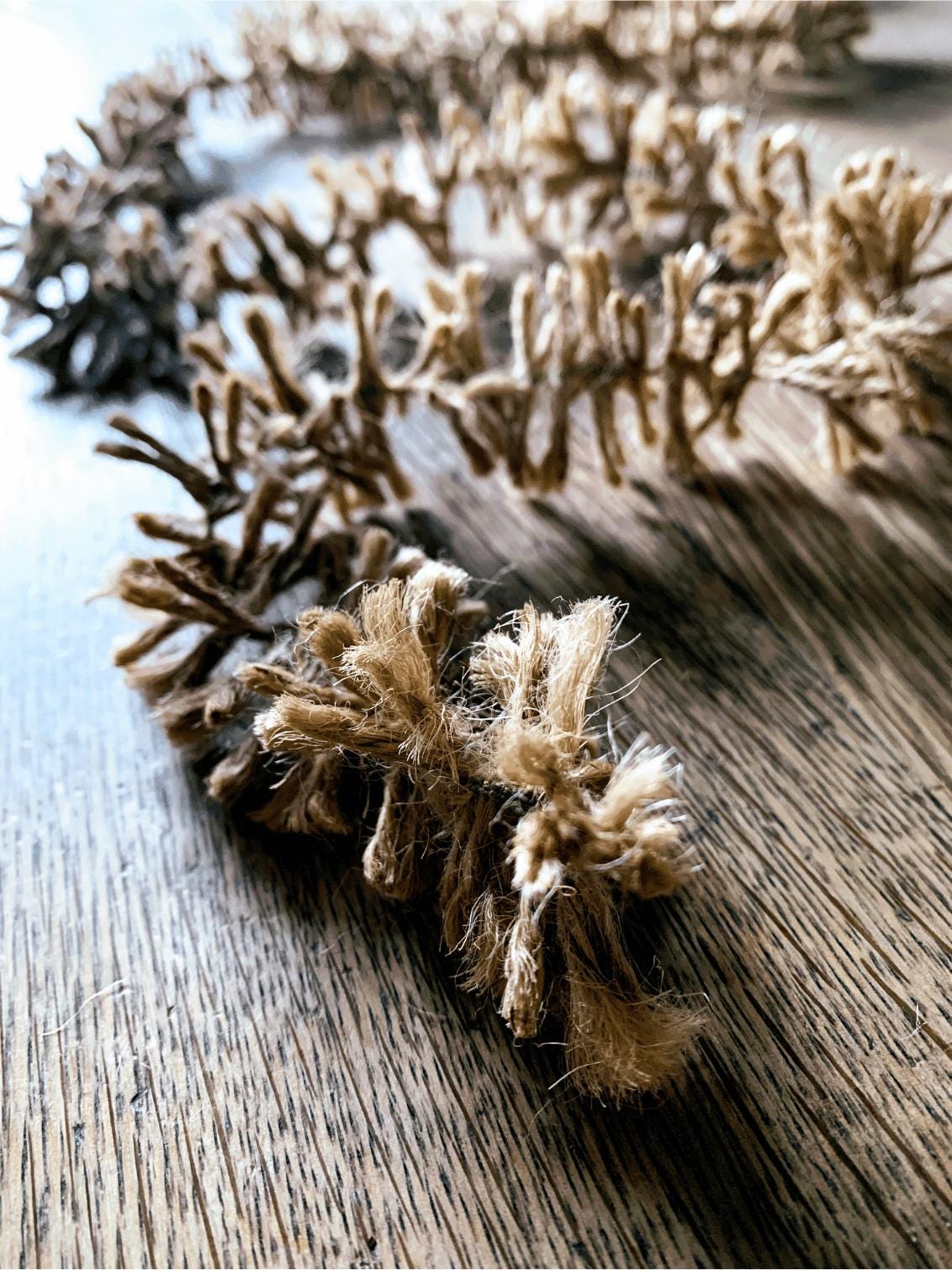Naturally golden Strinsel jute string tinsel garland packaging on a white background