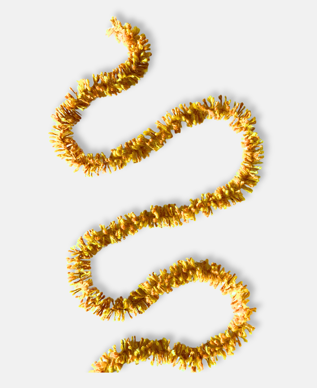 Bright gold Strinsel jute string tinsel on a pale grey background