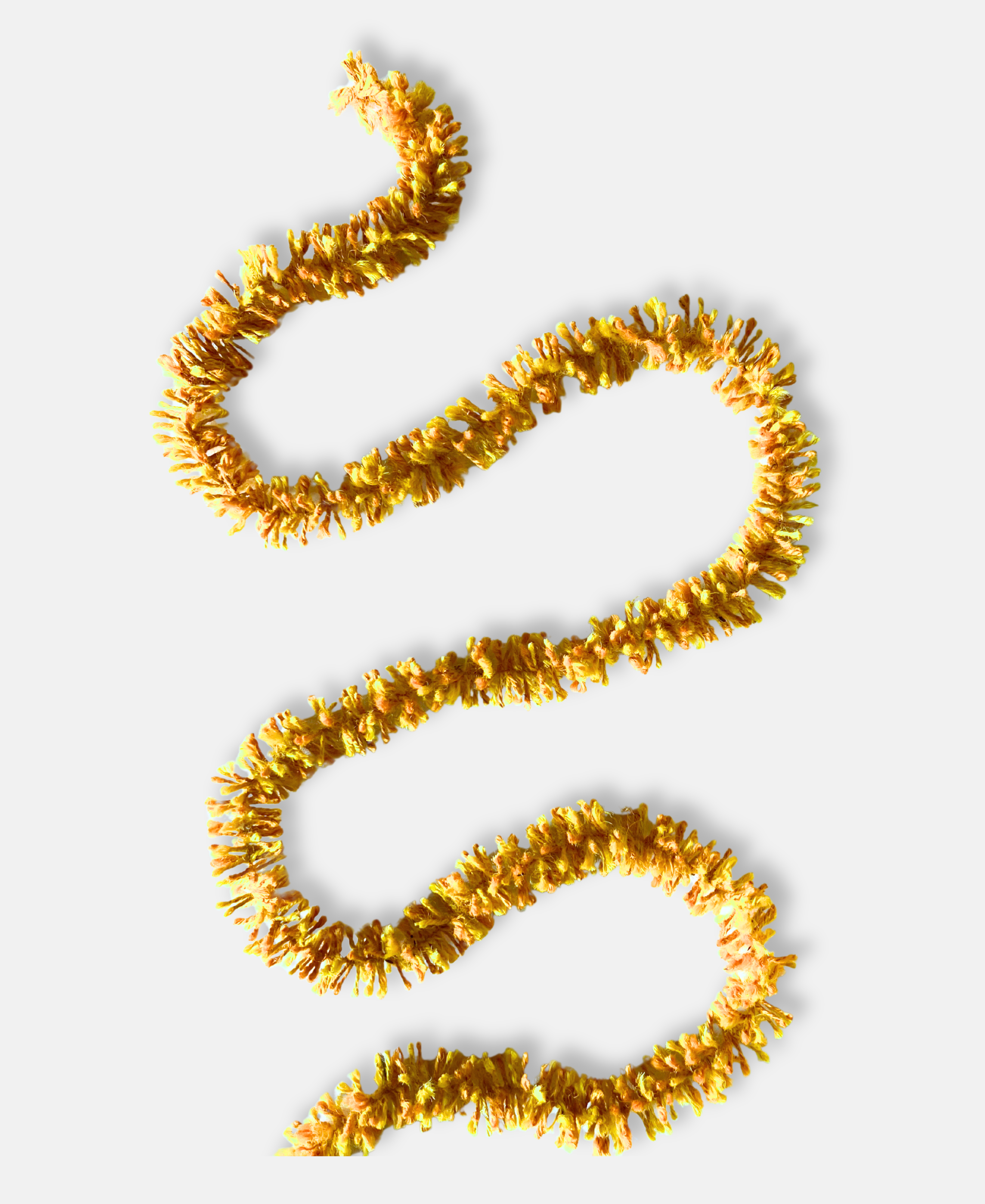 Bright gold Strinsel jute string tinsel on a pale grey background