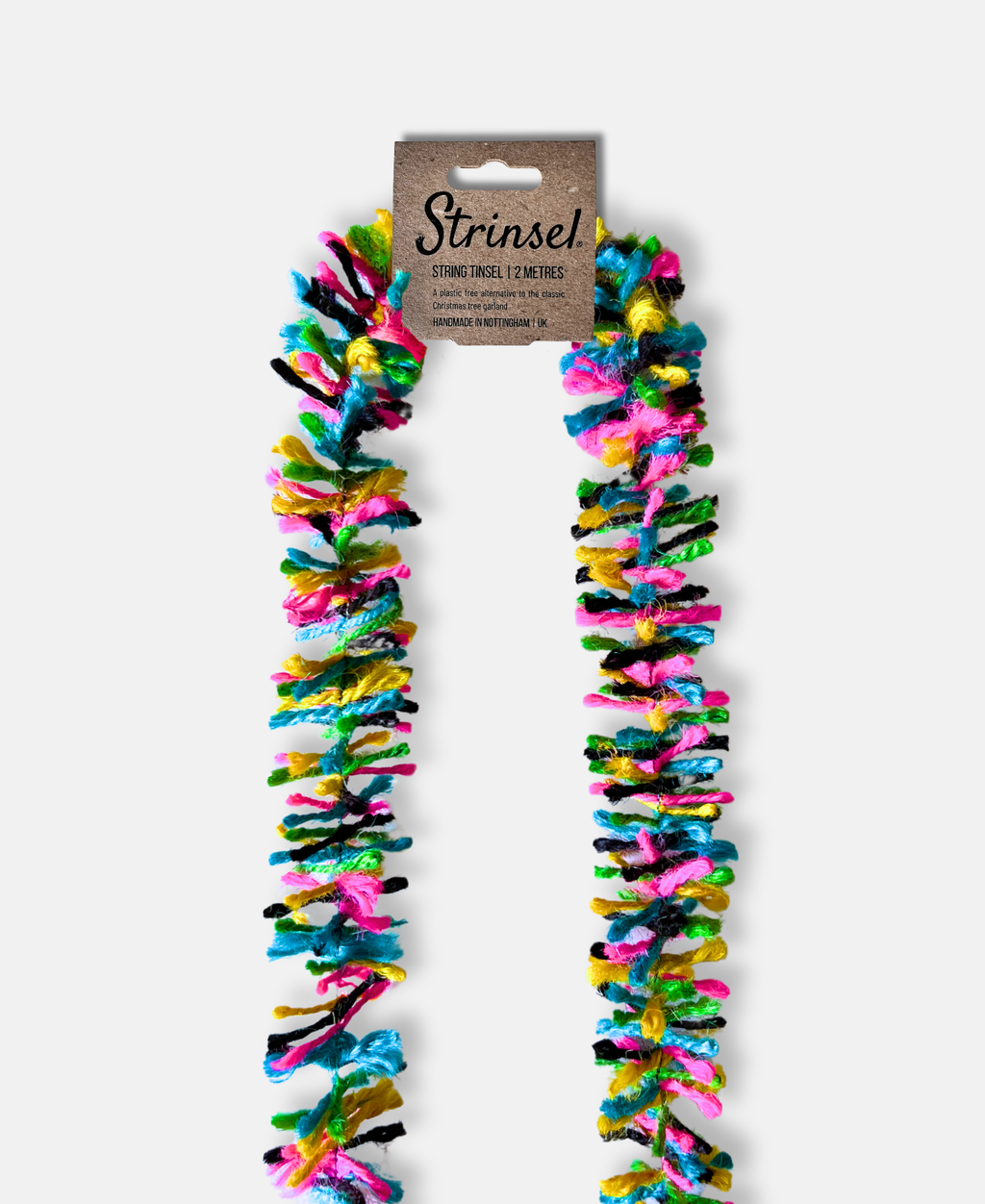 Disco Pop Strinsel jute string tinsel with packaging on a pale grey background