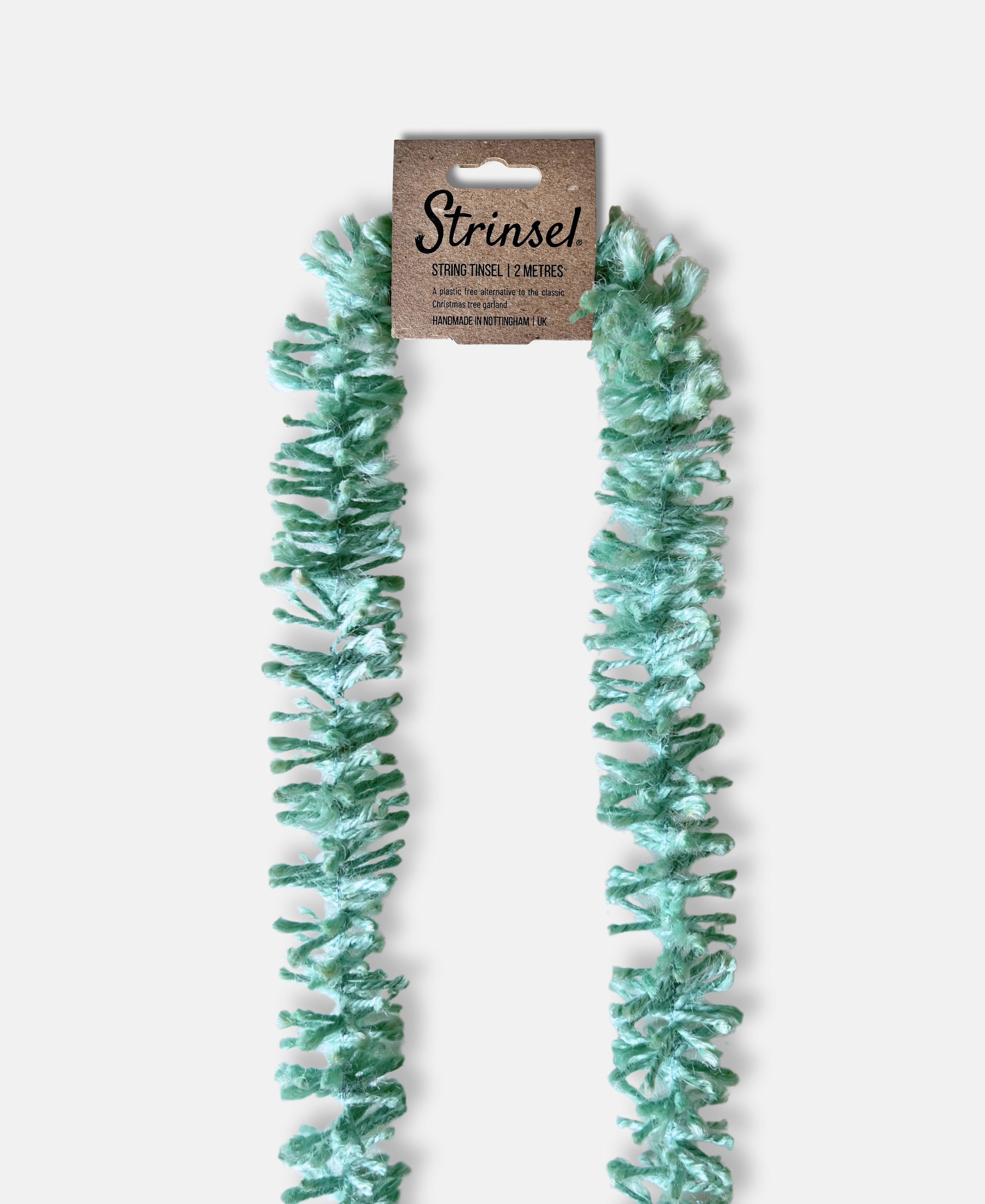 Duck Egg blue Strinsel jute string tinsel with packaging on a pale grey background