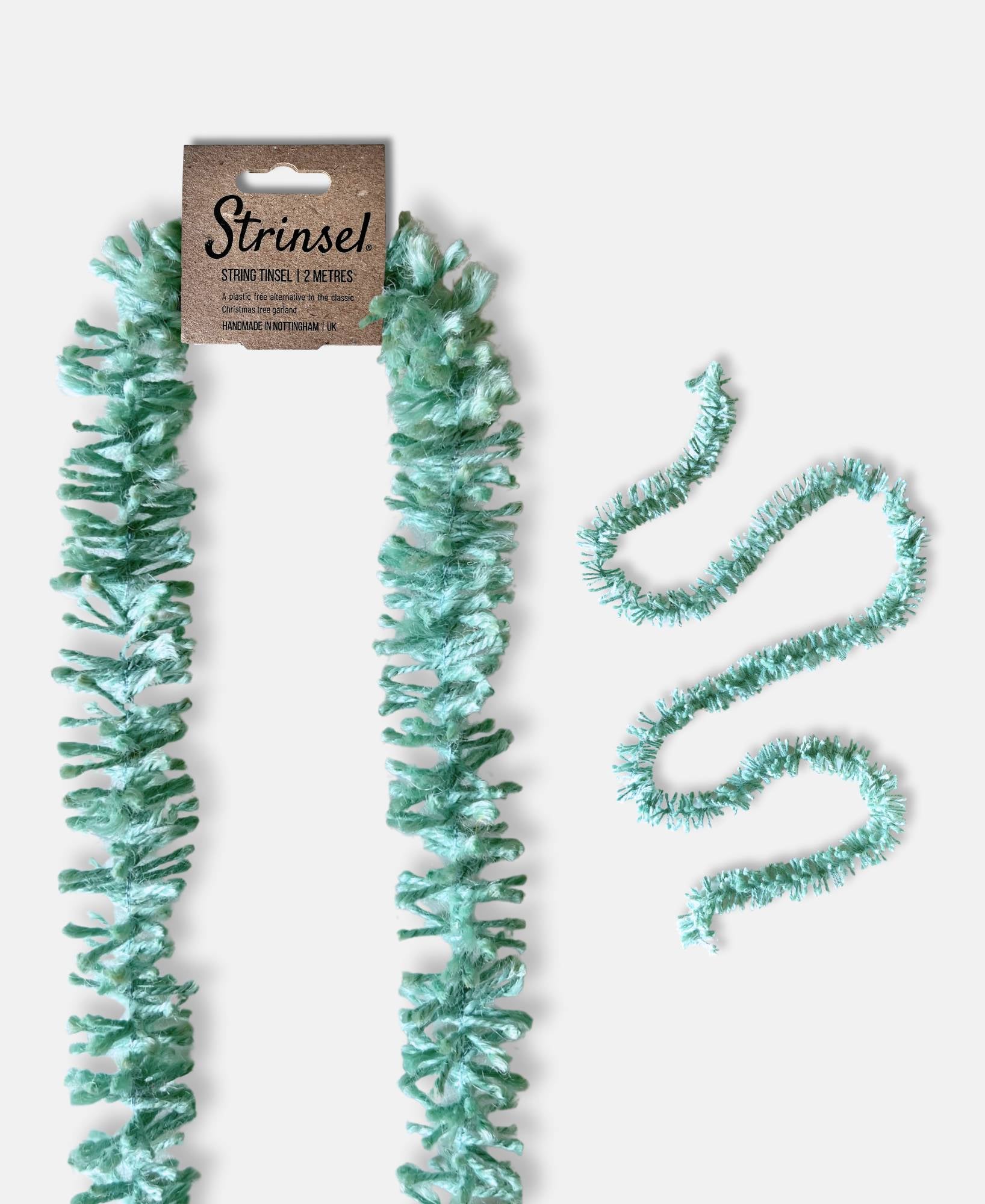 Duck Egg blue Strinsel jute string tinsel with and without packaging on a pale grey background