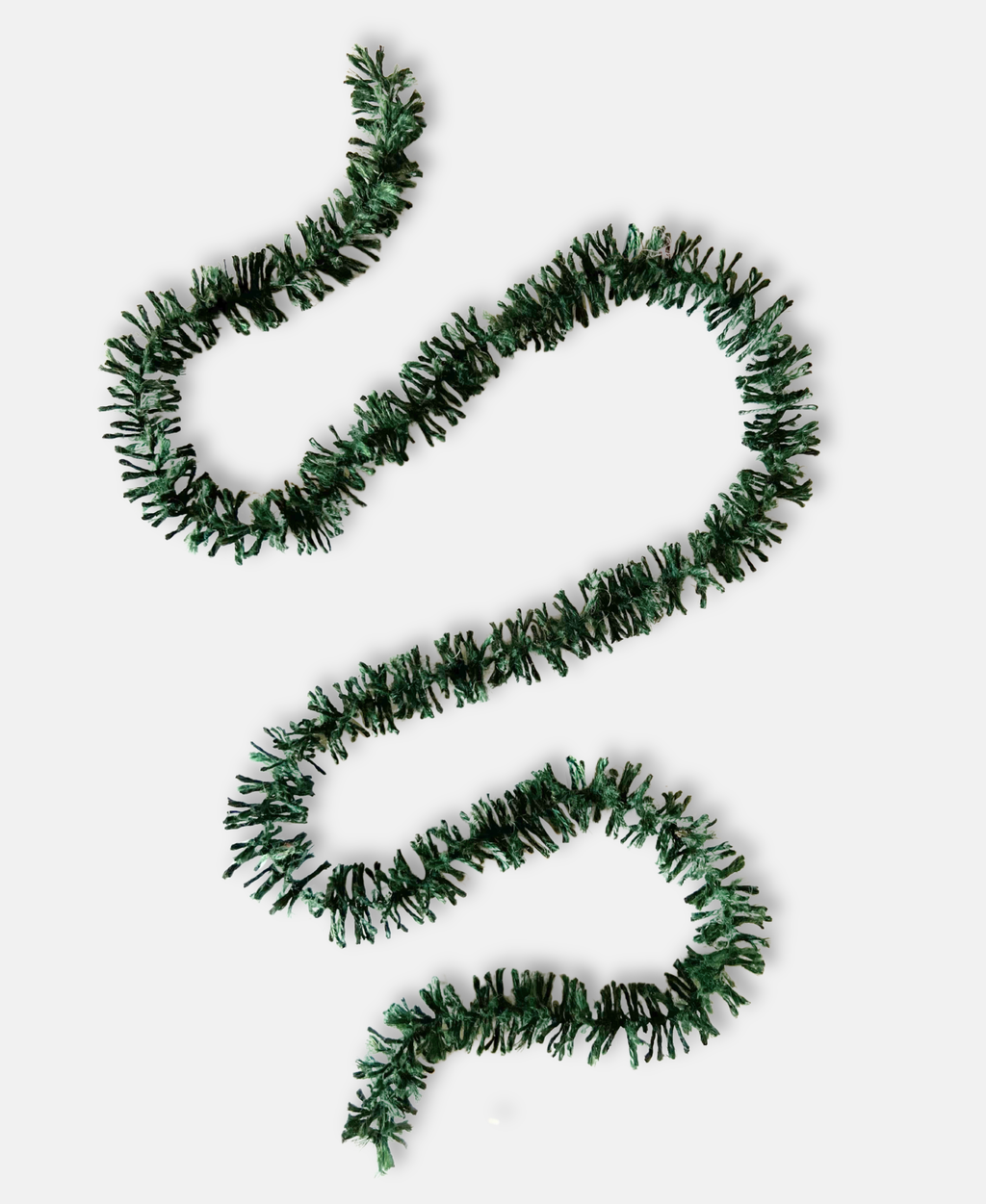 Forest Green Strinsel jute string tinsel without packaging on a pale grey background