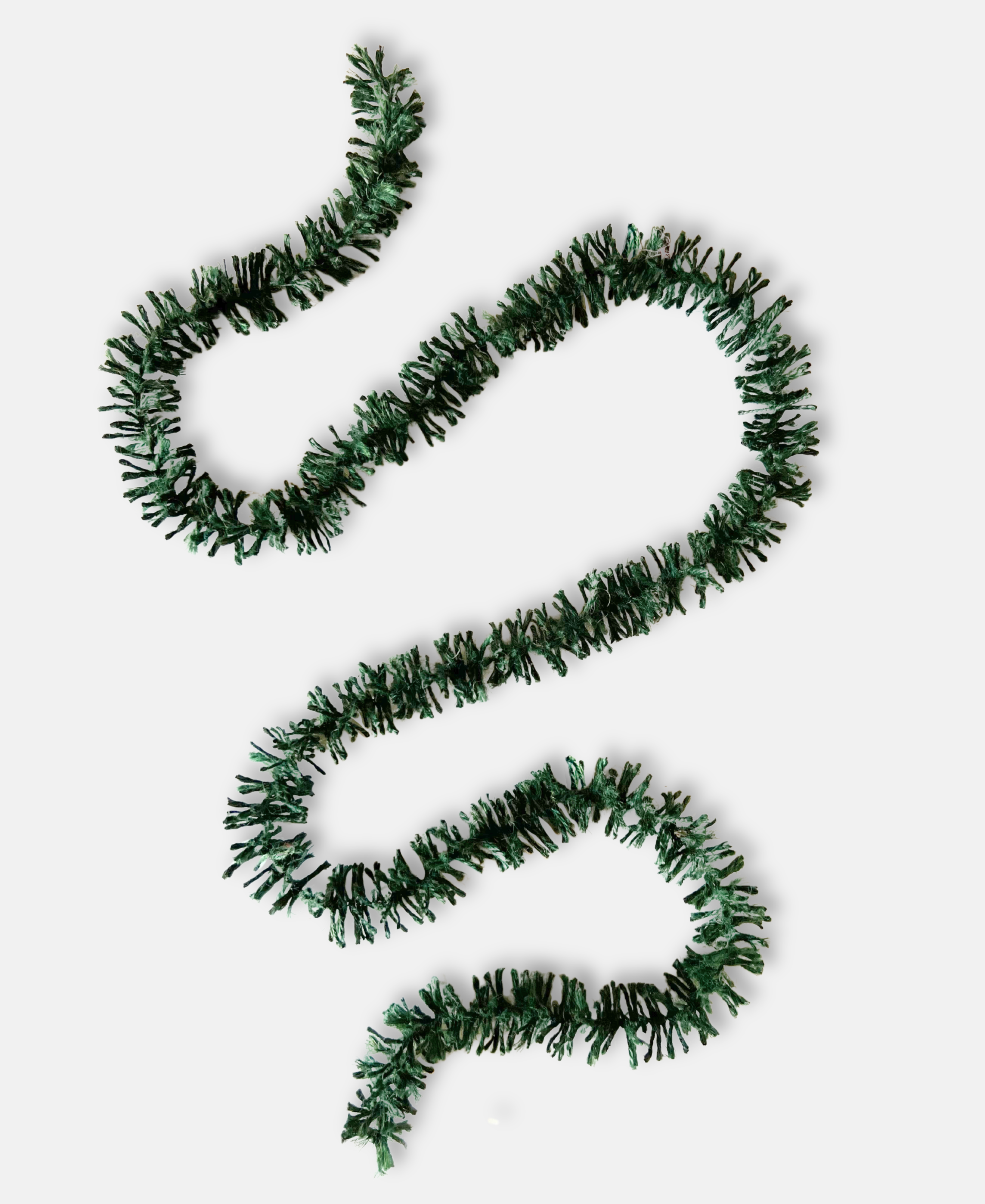 Forest Green Strinsel jute string tinsel without packaging on a pale grey background