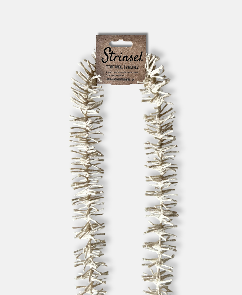 Decorative Strinsel string tinsel garland with packaging on a white background