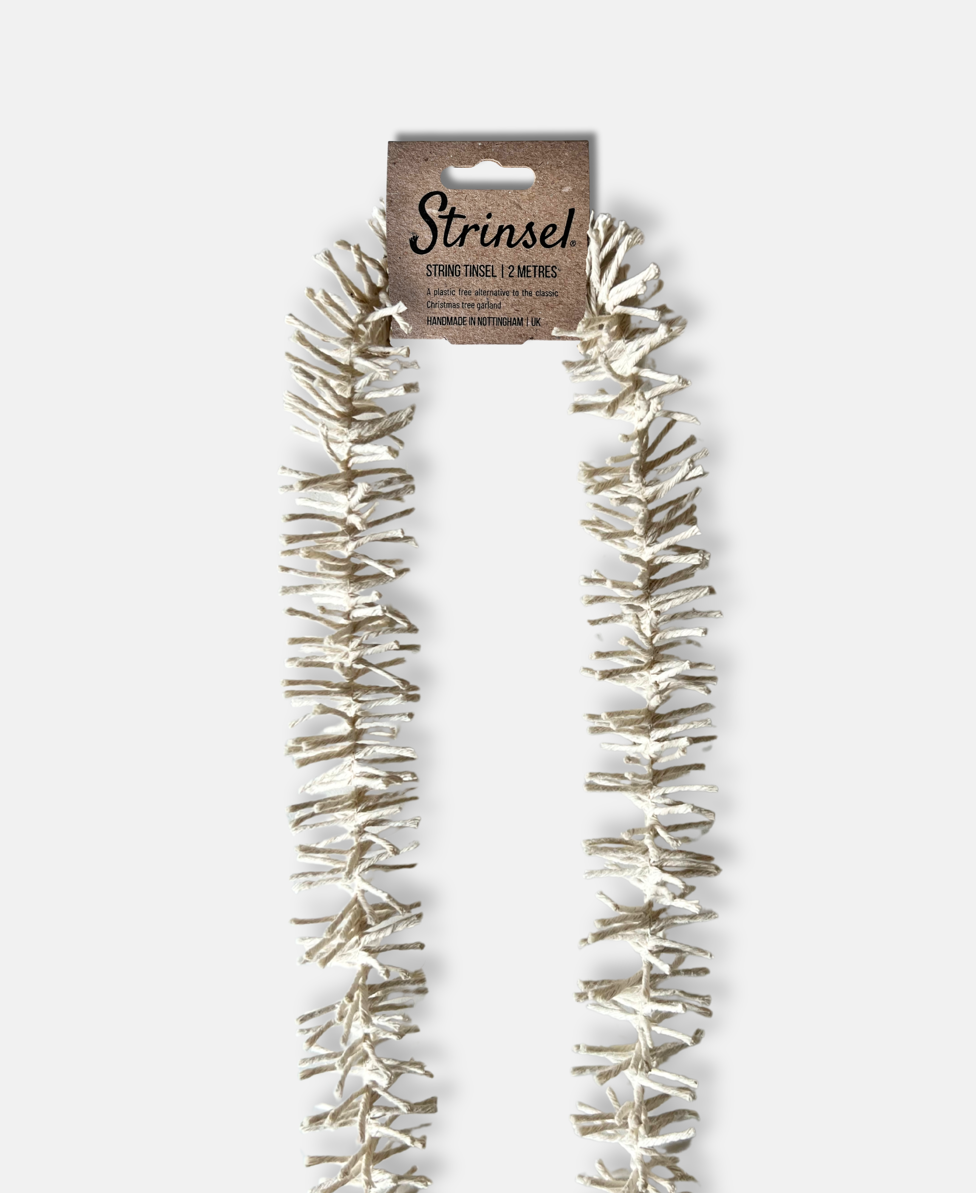Decorative Strinsel string tinsel garland with packaging on a white background