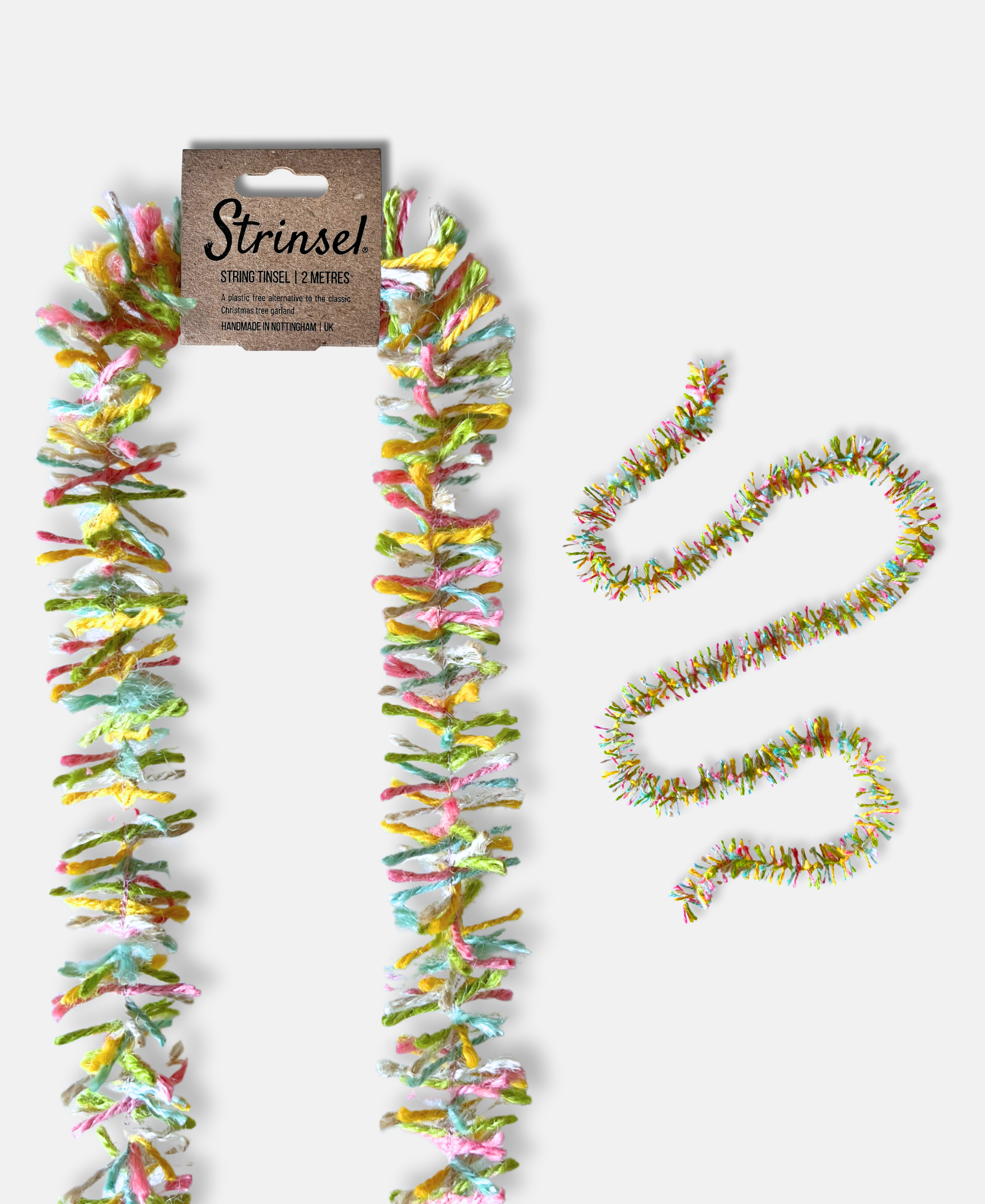 Pastel Pop Strinsel jute string tinsel with and without packaging on a pale grey background.