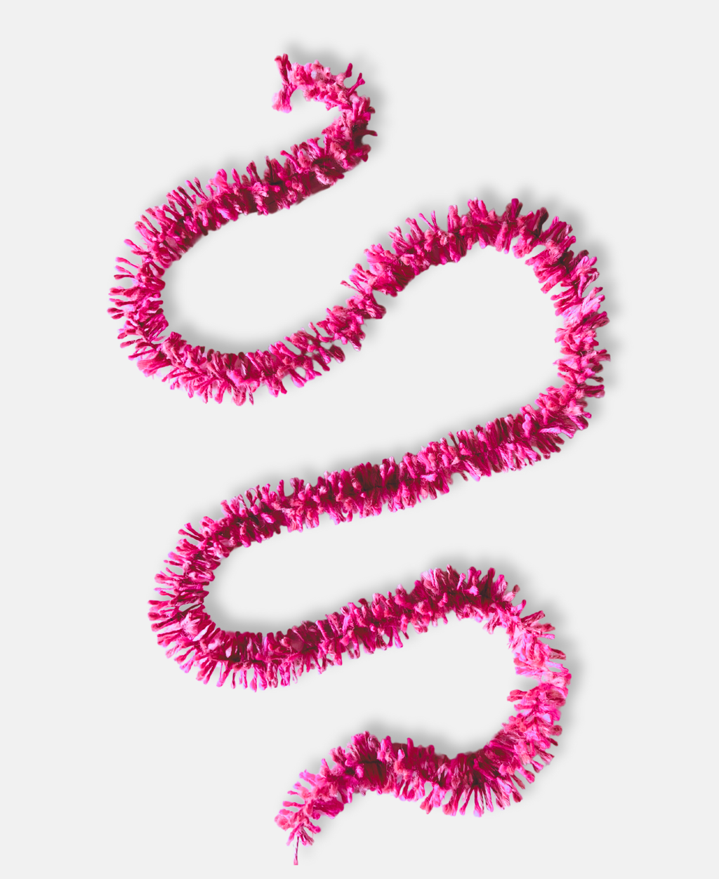 Pink Pop Strinsel jute string tinsel on a pale grey background