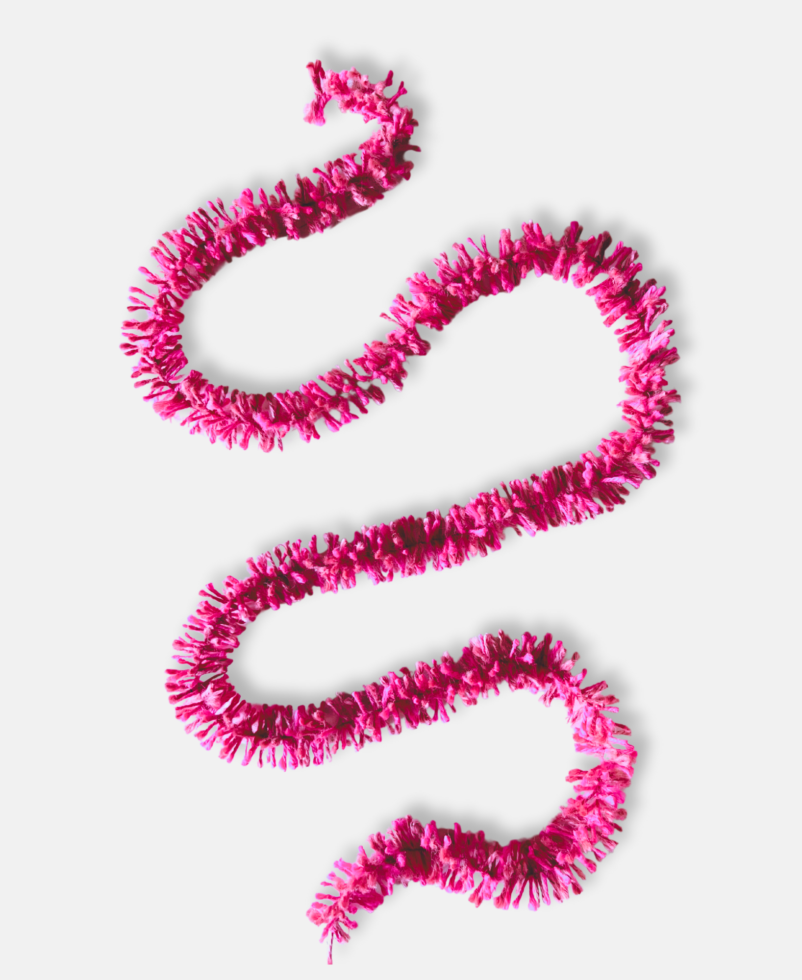 Pink Pop Strinsel jute string tinsel on a pale grey background