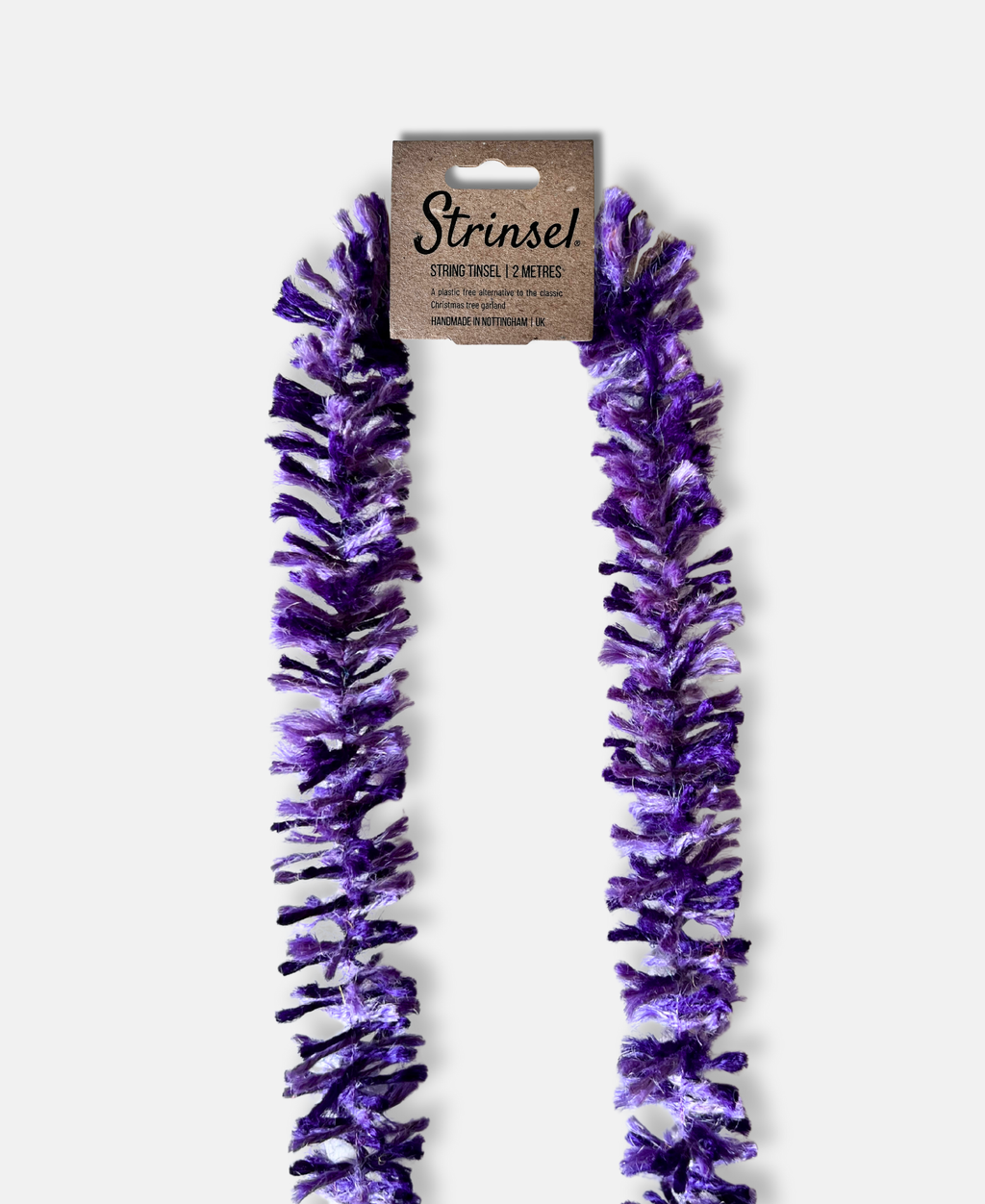 Purple Pop Strinsel jute string tinsel with packaging on a pale grey background
