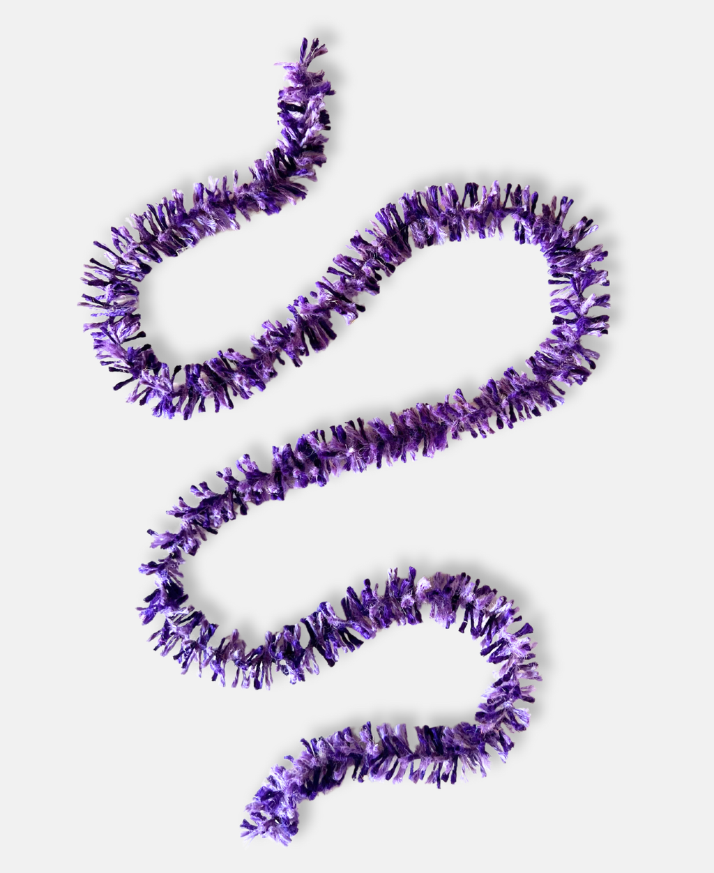 Purple Pop Strinsel jute string tinsel on a pale grey background