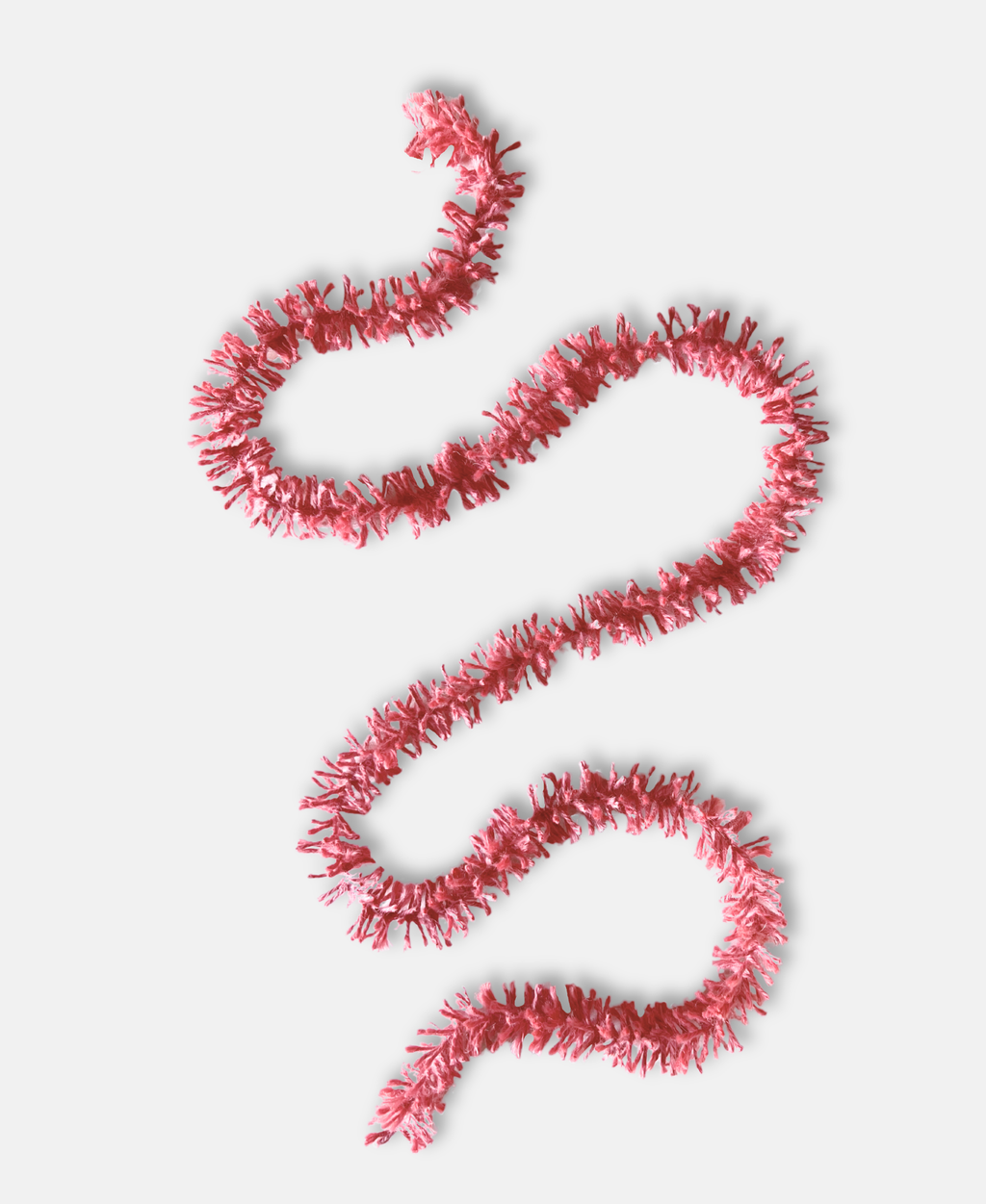 Soft pink Strinsel jute string tinsel on a pale grey background