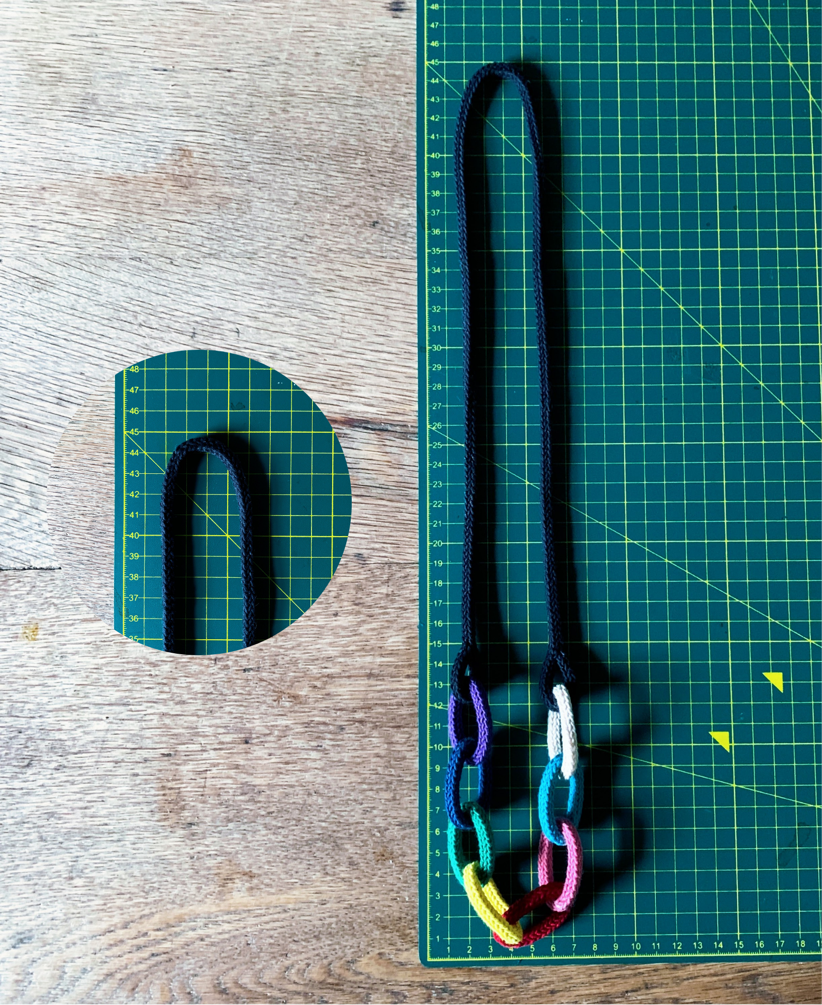 Chunky chain knitted string necklace showing size on a green cutting mat