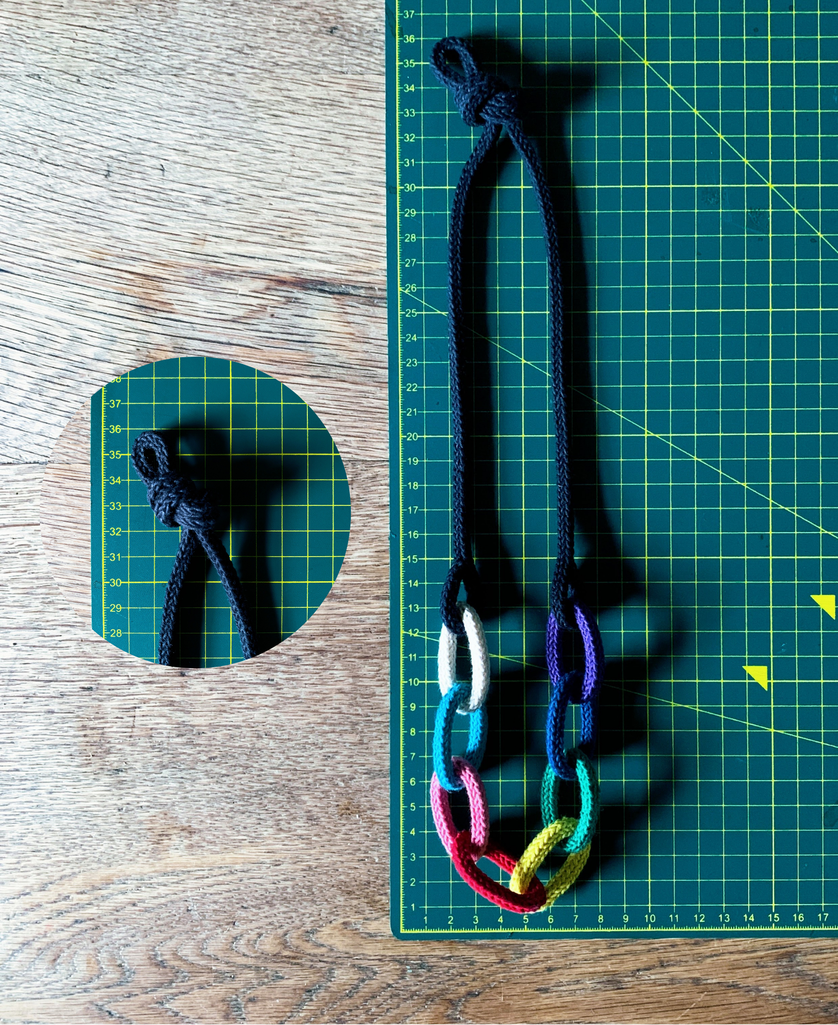 Knotted chunky chain knitted string necklace showing size on a green cutting mat