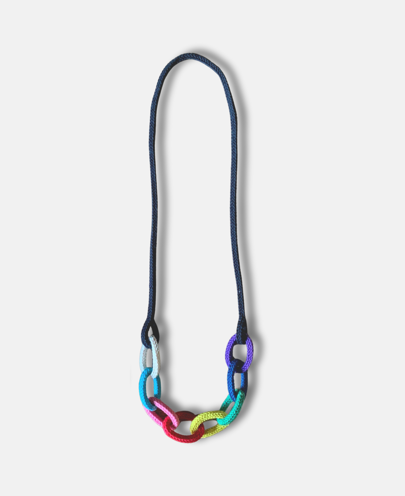 Rainbow themed chunky "string bling" necklace with black chain on a pale grey background