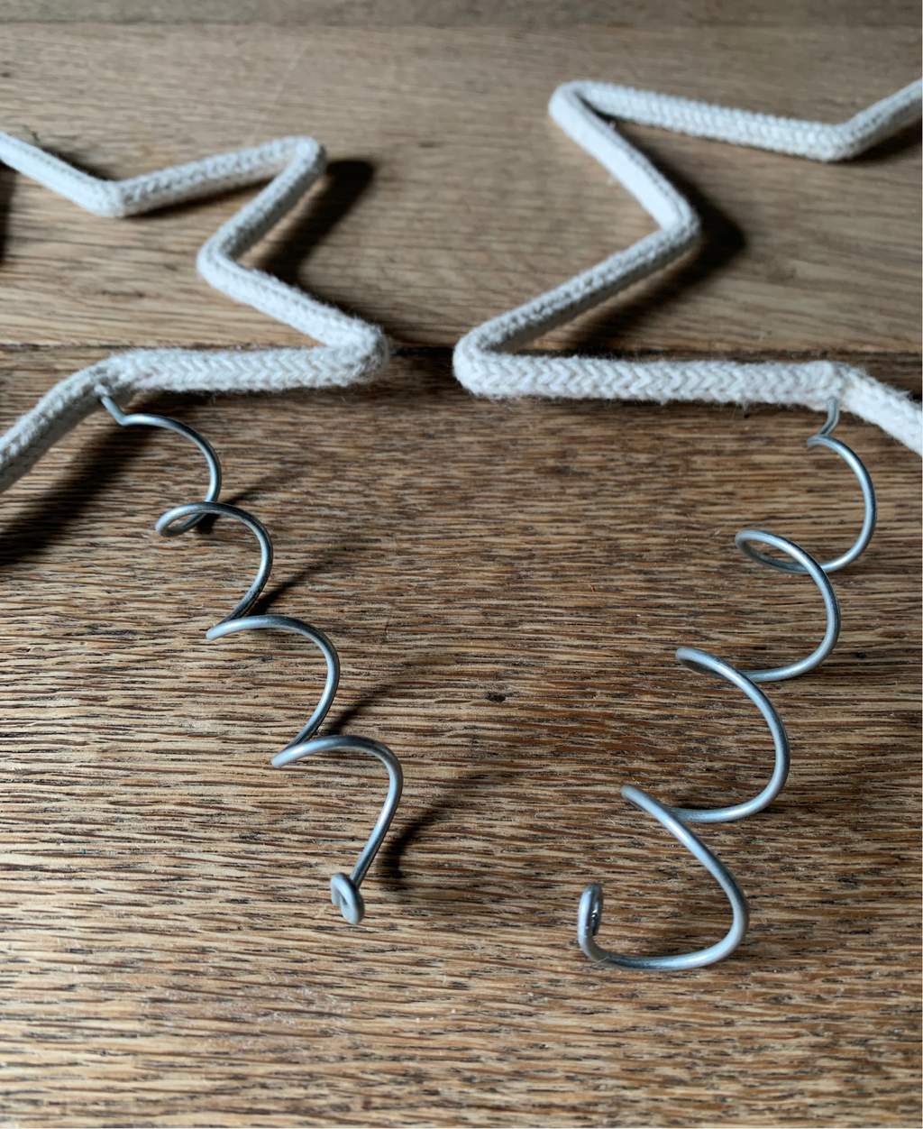 Christmas tree toppers with different width coils on a wooden surface