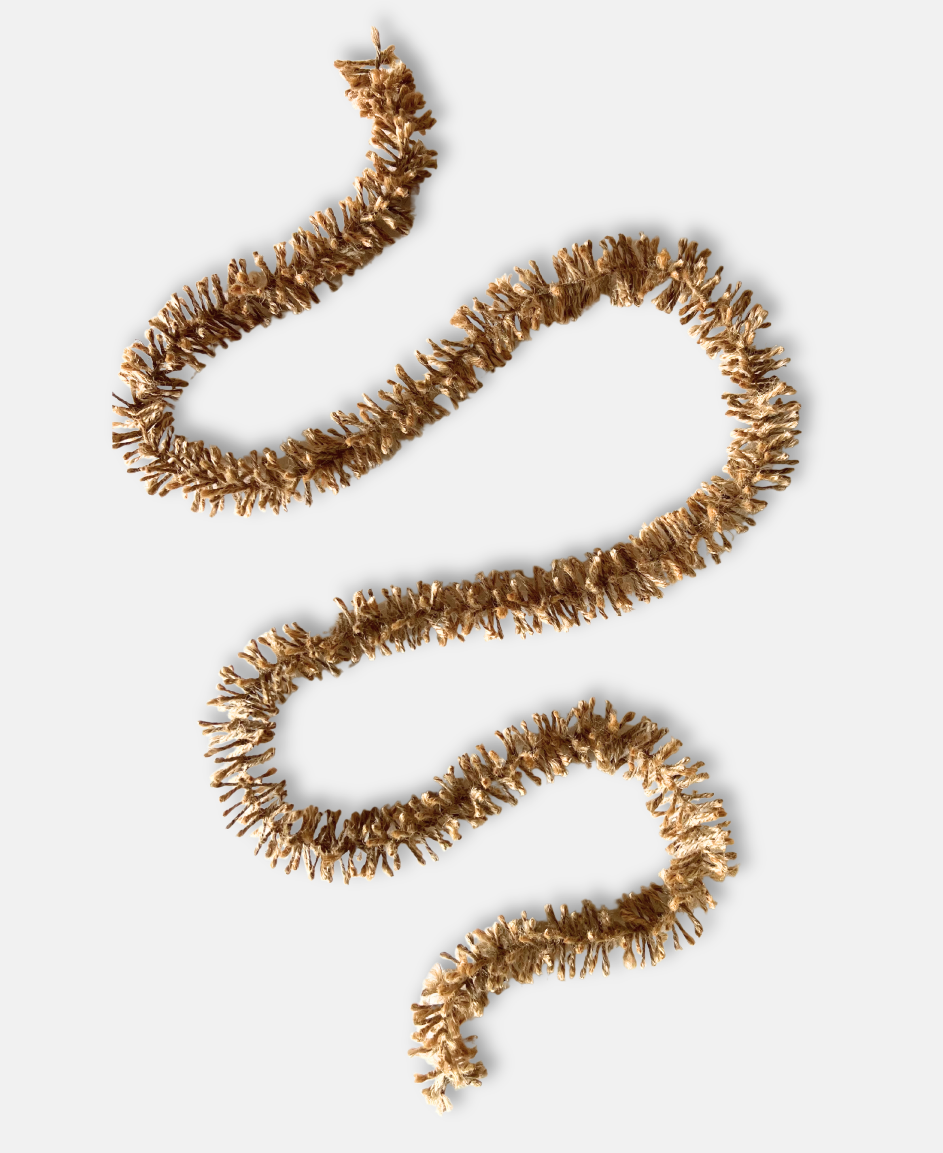 Naturally golden Strinsel jute string tinsel garland on a white background