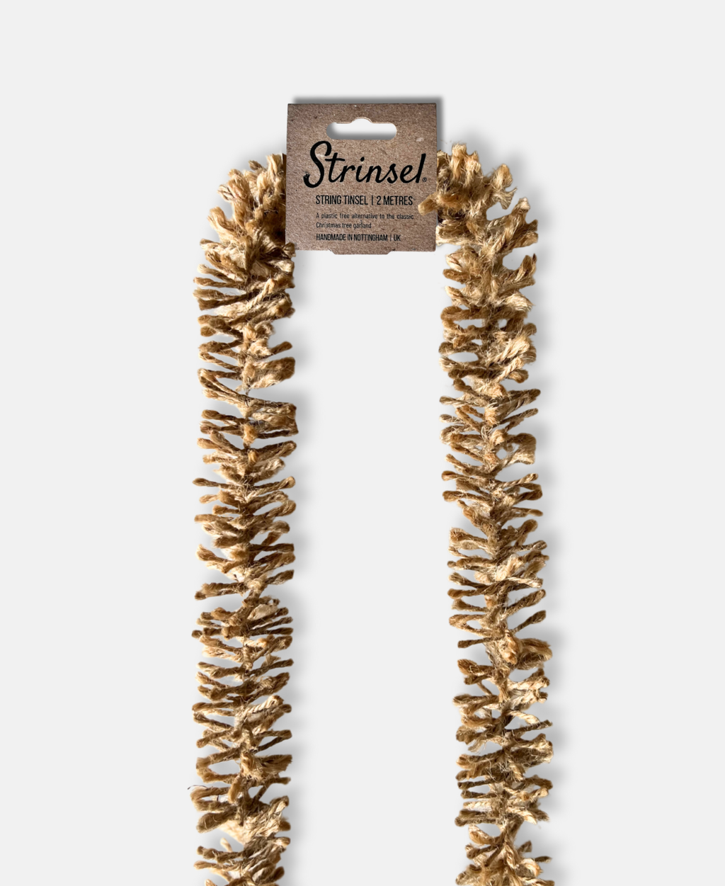 Naturally golden Strinsel jute string tinsel garland with packaging on a white background